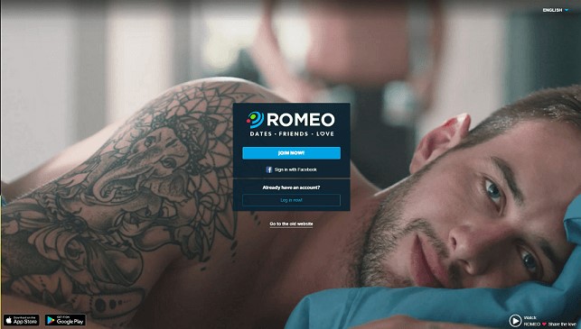 login-screen for planet romeo. handsome young gay single lying in bed after sex looking into the camera. a queer or homosexual  single in background is putting on his pants dressing himself. 
